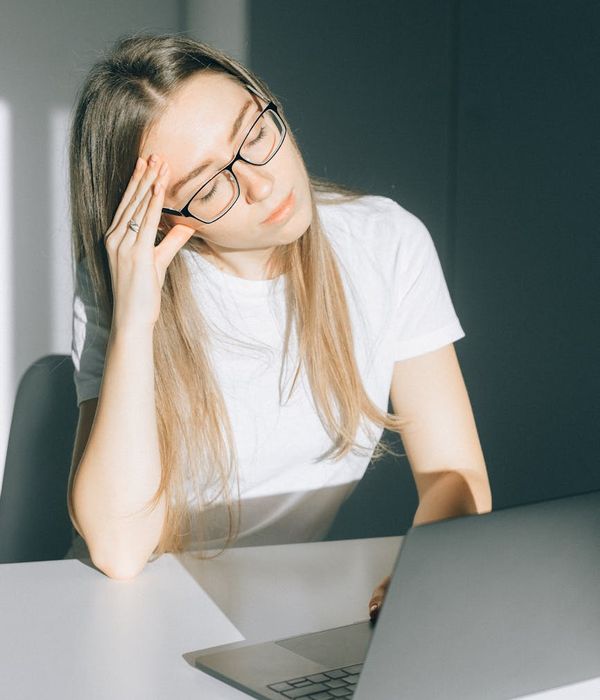 Woman doing a simple stretch at her office desk.